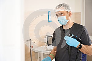 Doctor getting ready for endoscopy in procedure room