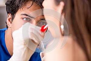 The doctor getting saliva test sample in clinic hospital photo