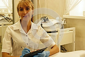 A doctor girl in a medical office recording a patient`s diagnosi