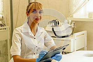 A doctor girl in a medical office recording a patient`s diagnosi