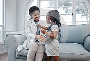 Doctor, girl and pediatrician woman with stethoscope, medical test and appointment with child on sofa. Healthcare