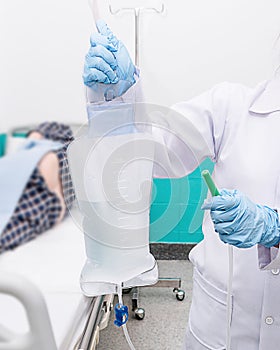 Doctor gives her patient for enema to resolve constipation problem. photo