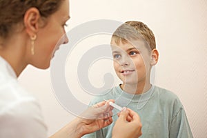 Doctor gives thermometer little boy
