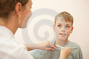 Doctor gives thermometer little boy