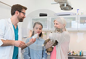 Doctor giving advise and medicine to cat`s owner at clinic