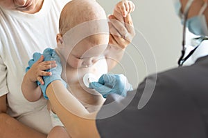 Doctor giving baby girl checkup in doctor office