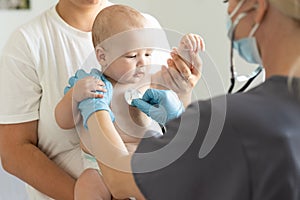 Doctor giving baby girl checkup in doctor office