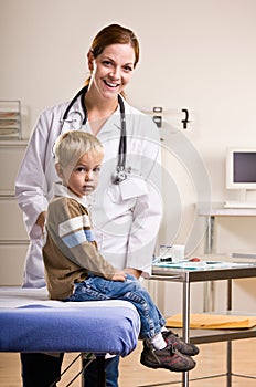 Doctor giving boy checkup in doctor office photo