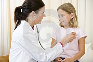 Doctor giving checkup with stethoscope photo