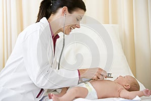 Doctor giving checkup with stethoscope photo