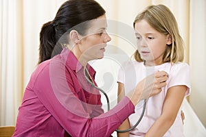 Doctor giving checkup with stethoscope photo