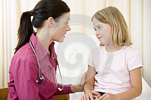 Doctor giving checkup to young girl
