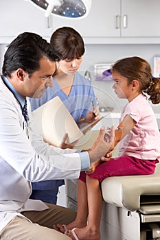 Doctor Giving Child Injection In Doctor's Office