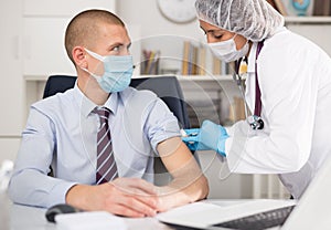 Doctor giving Covid-19 or flu antivirus vaccine shot to patient