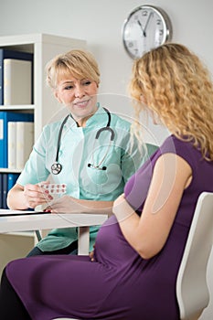 Doctor giving a folic acid