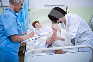 Doctor giving foot treatment to patient