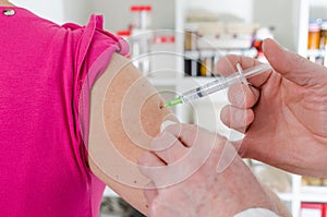 Doctor giving an injection to his patient