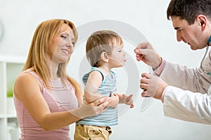 Doctor giving medicament with a spoon