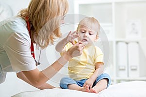 Doctor giving medicament with a spoon