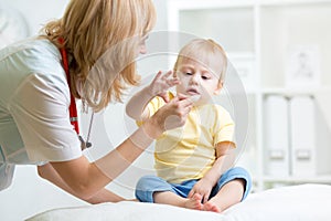 Doctor giving medicament with a spoon photo