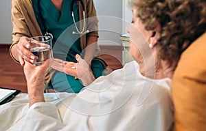 Doctor giving medication dose to elderly patient