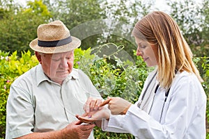 Doctor giving medication to elderly