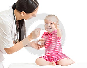 Doctor giving medicine to baby girl
