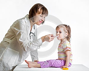 Doctor giving medicine to baby girl isolated on white