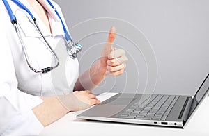 Doctor giving online consultation to patient and showing thumb up gesture. Telemedicine, telehealth concept. Woman with