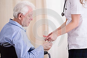 Doctor giving patient medicament photo