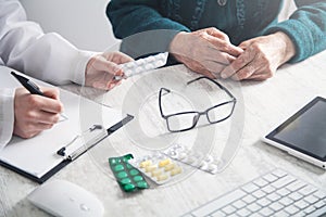 Doctor giving pills to elderly woman. Health, Medicine, Care