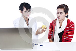 Doctor giving prescription to patient