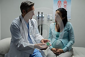 Doctor giving prescription to pregnant woman