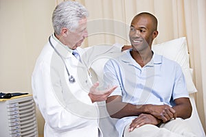 Doctor giving smiling man checkup photo