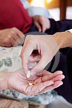 Doctor giving some pills to a senior woman