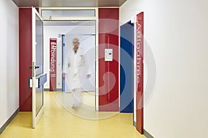 Doctor with glasses walks in the corridor of the hospital