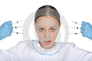 Doctor in gloves holding syringe front of face