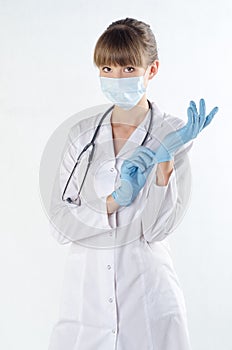 Doctor in gloves and mask, isolate on gray