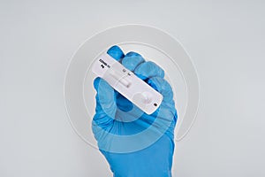 Doctor hand with blue glove holding Rapid antigen test Rapid Strep Test RST kit, COVID-19 virus disease healthcare check