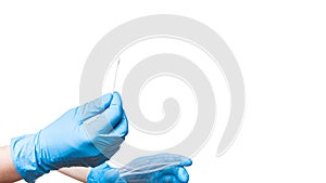 Doctor hand in blue sterile glove holds sealed bag and give cotton swab.