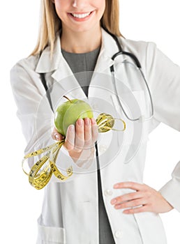 Doctor With Hand On Hip Showing Green Apple And Tape