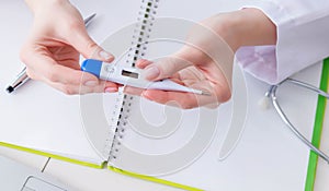 Doctor hand holding temperature thermometer