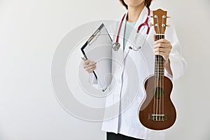 Doctor hand holding ukulele musical instrument, Music therapy