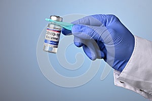 Doctor Hand Holds Covid-19 Vaccine with Pincet