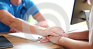 Doctor hand man calms female patient in clinic