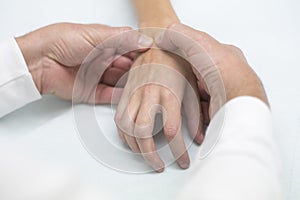 Doctor hand Physicist physical therapy treatment patient in the clinic. Orthopedic medical exam in doctor`s hospital office Partne photo