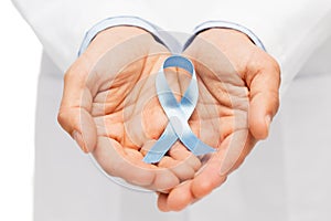Doctor hand with prostate cancer awareness ribbon