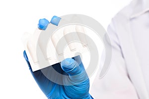 Doctor hand in sterile gloves holding rectal suppositories isolated on white background  close up view  - Image