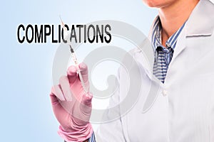 Doctor hand in sterile gloves holding syringe  on blue  background  complications- Image