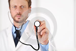 Doctor hand with a stethoscope pointing screen, medical care concept copy space on white background